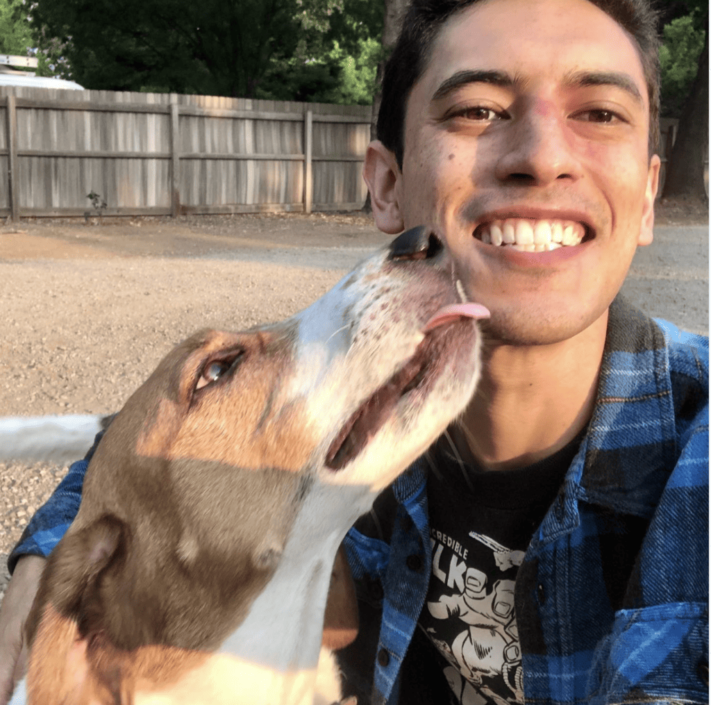 Jonathan receives wet kisses from a dog